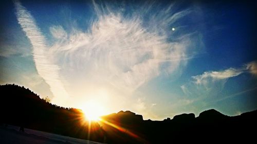 Scenic view of mountains against sky at sunset