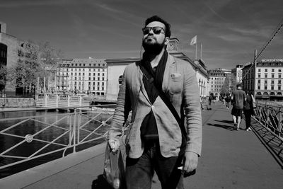 Portrait of young man standing in city