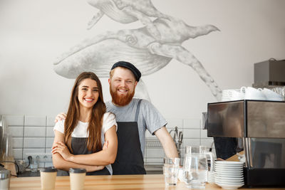 Portrait of smiling young woman sitting on table