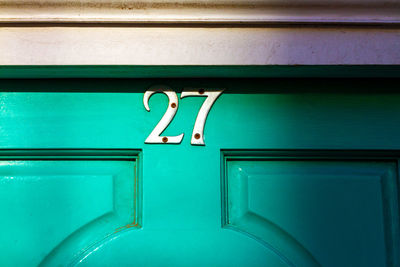 House number 27 on a wooden front door 