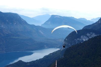 Woman paragliding against sky