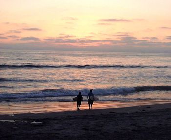 People on beach at sunset