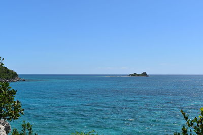 Scenic view of sea against clear blue sky