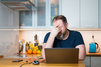 Man using laptop on table