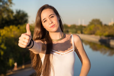 Close-up of beautiful woman showing thumbs up