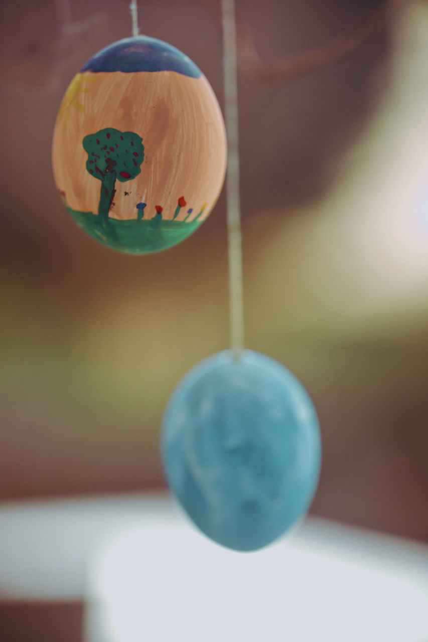 CLOSE-UP OF CRYSTAL BALL HANGING ON PAPER