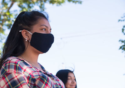 Young argentinian brunette woman wearing face mask