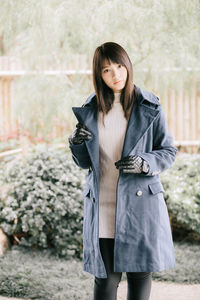 Portrait of young woman standing outdoors