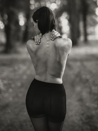 Rear view of woman standing outdoors