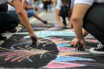 Low section of people drawing on footpath