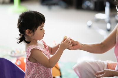 Close-up of cute girl holding hands