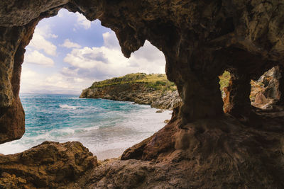 Scenic view of sea seen through cave