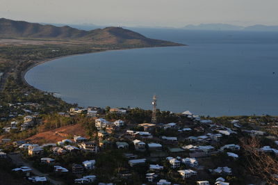 High angle view of townscape by sea against sky