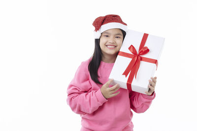 Portrait of a smiling young woman against white background