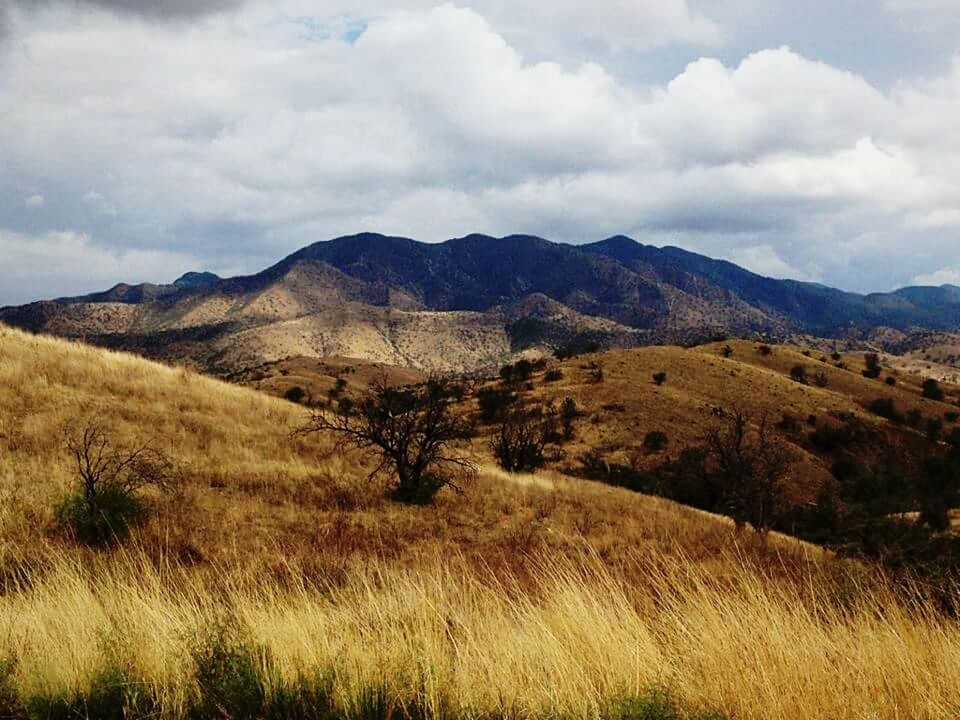 mountain, tranquil scene, landscape, sky, tranquility, scenics, mountain range, beauty in nature, cloud - sky, nature, cloud, non-urban scene, physical geography, remote, cloudy, grass, idyllic, horizon over land, day, geology