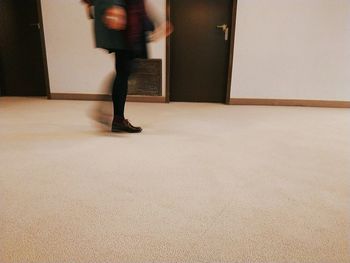 Low section of woman standing on tiled floor