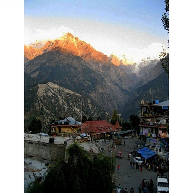 mountain, building exterior, transfer print, built structure, architecture, house, sky, auto post production filter, mountain range, town, residential structure, townscape, residential building, high angle view, residential district, village, sunlight, incidental people, day, outdoors