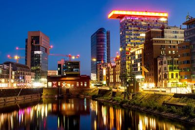 Reflection of illuminated buildings in city at night