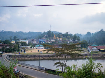 High angle view of river amidst buildings against sky