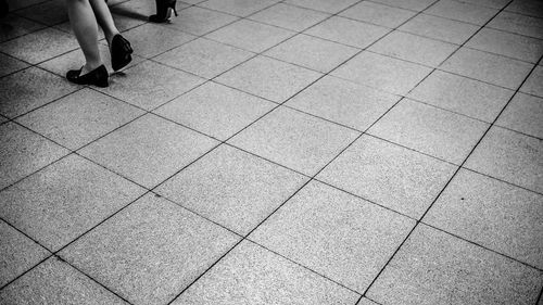 Low section of woman on tiled floor