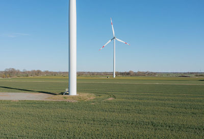 Windmill on field against sky