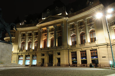 Illuminated building in city at night