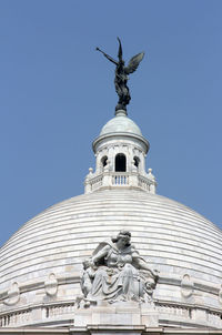 Statue on structure with sky in background