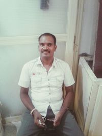 Portrait of a smiling young man at home