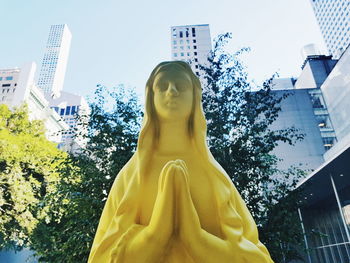 Low angle view of statue against building