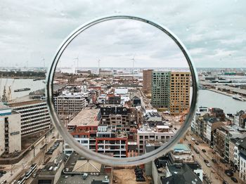 High angle view of modern buildings in city against sky