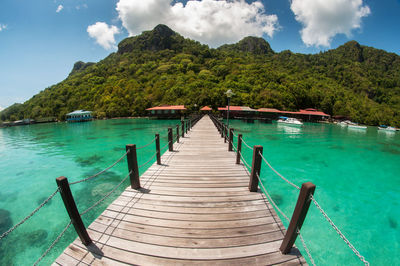 Jetty in sea against sky