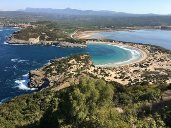 High angle view of sea and mountains against sky