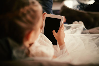 Midsection of woman using digital tablet