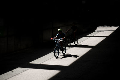 Boys riding bicycle in city