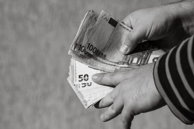 Cropped hand holding paper currency