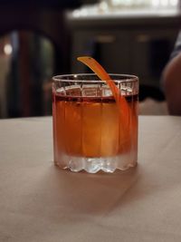 Old fashioned cocktail in a clean whiskey glass, garnished with an orange twist