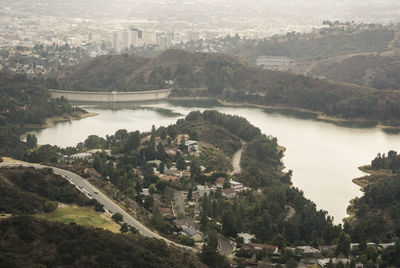 Scenic view of river by city