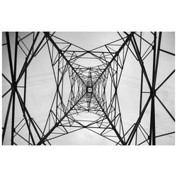 Low angle view of electricity pylon against sky