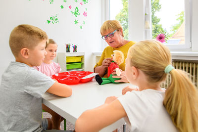 Children speech therapy concept. children practicing pronunciation with a female speech therapist. 