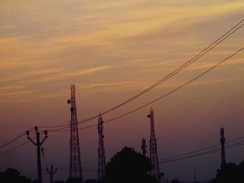 Low angle view of electricity pylon against sky