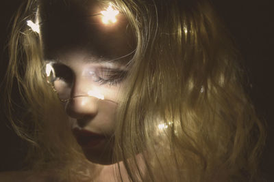 Close-up of woman with glowing fairy lights