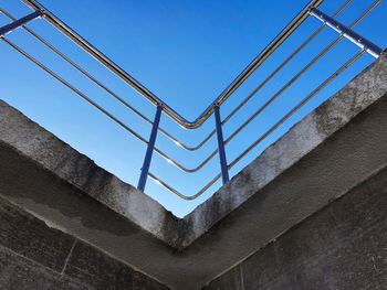 Low angle view of staircase against blue sky