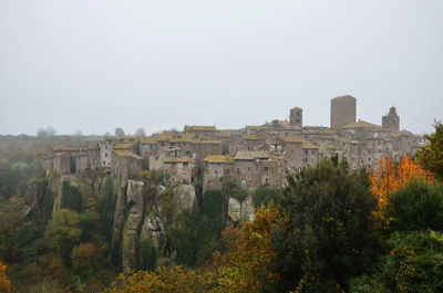 Buildings against clear sky during autumn