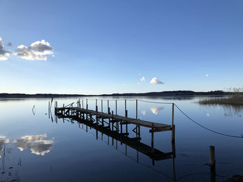 Pier on lake against sky