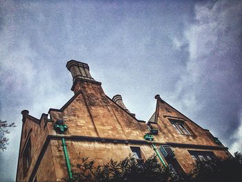 Low angle view of building against cloudy sky