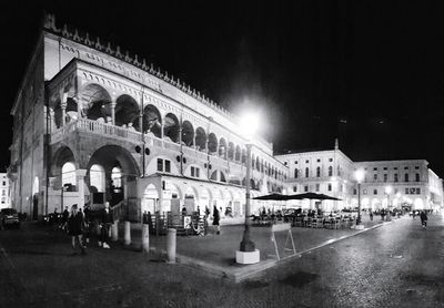 Group of people in front of building at night