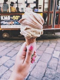 Human hand holding ice cream cone