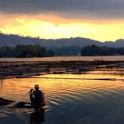 Scenic view of lake at sunset