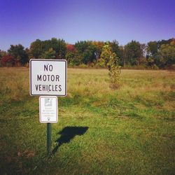 Information sign on grassy field