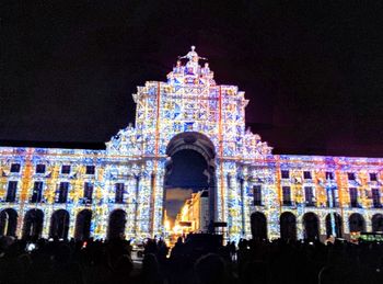 Low angle view of tourists at night